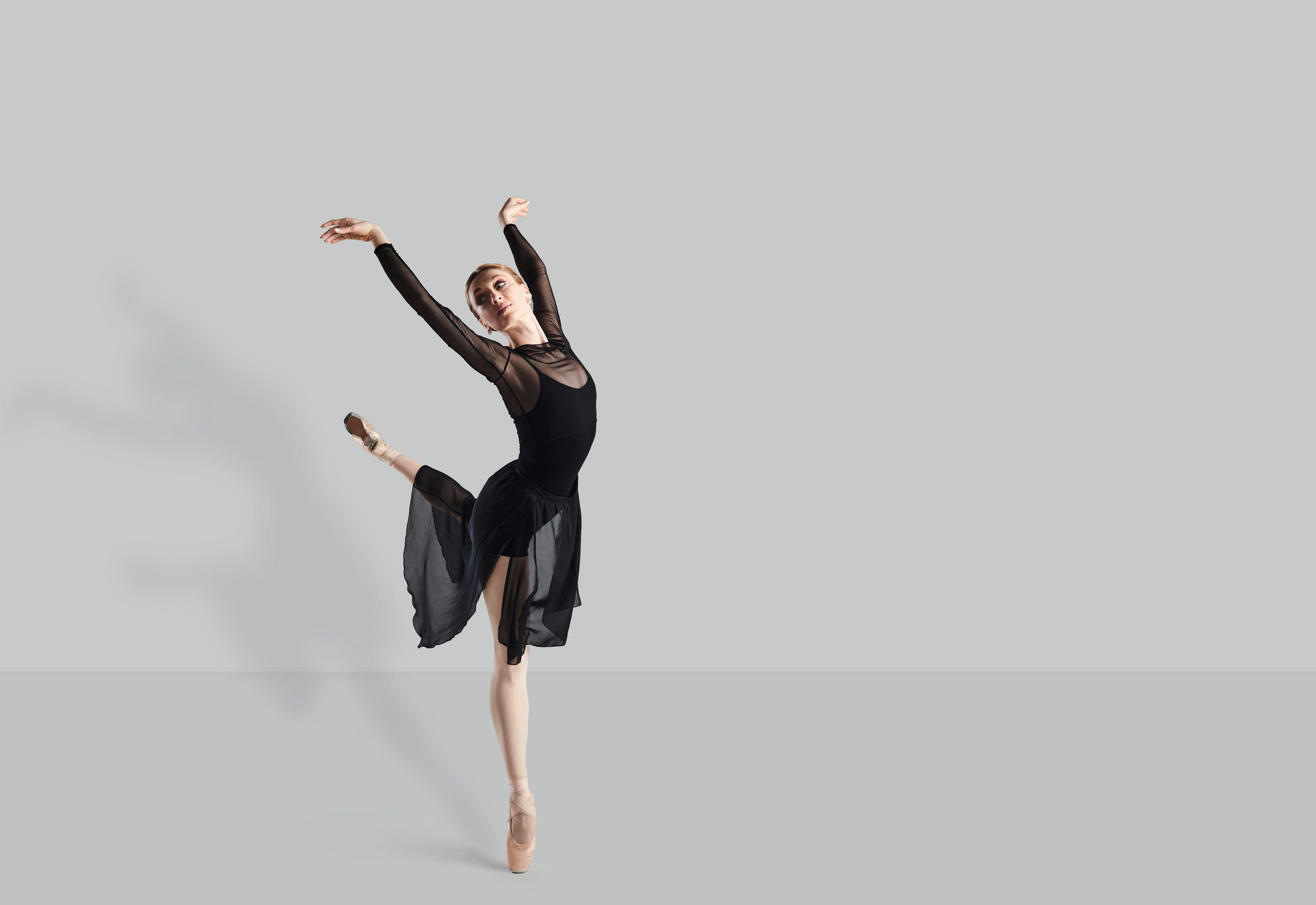 Female Ballet Dancer Dancer over Gray Background.